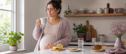 Pregnant person in a calm kitchen noticing a strange taste while holding a mug near lemon water, tea, and crackers.